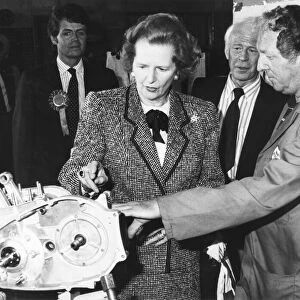 Baronnes Margaret Thatcher accompanied by Patrick Nicholls (left