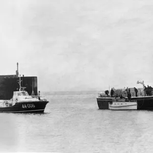 The Barry lifeboat and the Royal Navy Auxiliary ship Odiman escorts the small craft