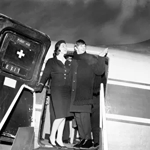Beatles drummer Ringo Starr with air stewardess as he boards a plane