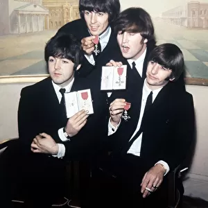 The Beatles pose with their MBEs at a press conference held at the Saville Theatre