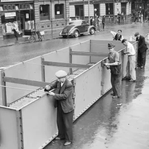 Birmingham council workmen construct an emergency water container in the city centre