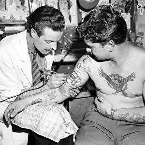 Blackpool tattooist Harry Lever tattoos a client. The new craze is for television heroes