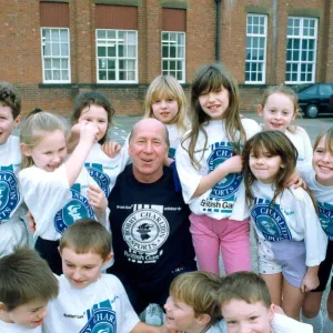 Bobby Charlton with children from Cavendish First School in Ashington in January 1992