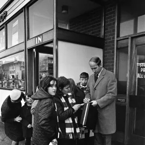 Bobby Charlton is met by autograph hunters as he leaves Old Trafford for London