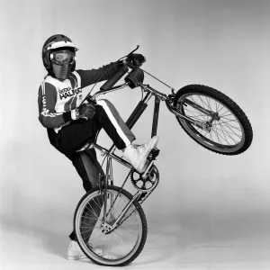 A boy with a BMX bike and wearing a BMX outfit. 25th November 1983