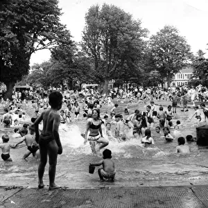 Children enjoying the sunshine having fun in the Victoria Park pool, Cardiff