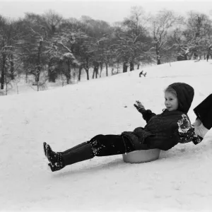 Children sledging on washing up bowls in Greenwich Park, London, 27th December 1970