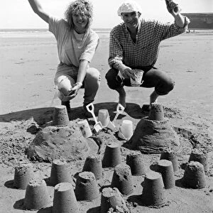 Chris Bird and Carole Smithson get in some practice at the sandpit building for