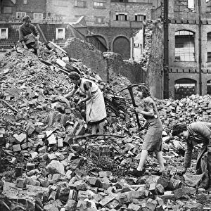 Civilians search through bombed houses for salvage in Bristol during Second World War