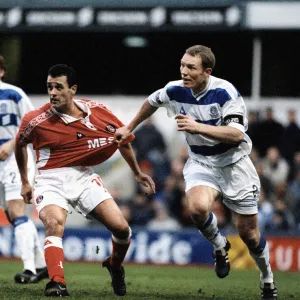 Clive Mendonca of Charlton has his shirt pulled by Tim Breacker of Queens Park Rangers