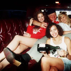 Comedian Benny Hill in a car with some of his Hills Angels