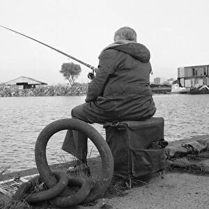 A competitor in the Daily MIrror Angling Competition at Surrey Docks, London