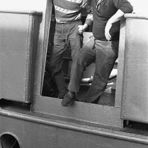 Crewman of the trawler Magritte seen here having a cigarette whilst tied up at St Andrews