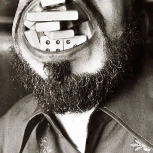 Dave Foster sets a record by cramming in 28 domino pieces into his mouth at his local pub