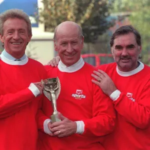 Denis Law with Bobby Charlton and George Best hold 1966 World Cup replica