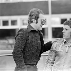 Elton John with a fan. 22nd December 1973