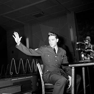 Elvis Presley wearing army uniform waves at press conference in Germany, March 1960