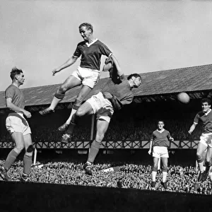 Everton footballer Alex Young and Ipswich goalkeeper Hall go up for a corner kick