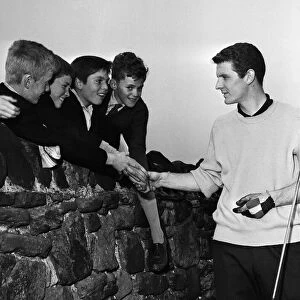 Everton footballer Brian Labone with schoolboy admirers after a round of golf at Bootle