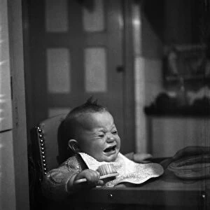 Expressions. An 11 month old child crying for his food. January 1950 O22295-001