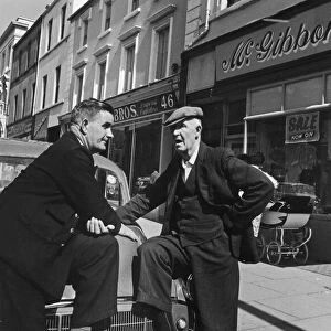 To gentlemen seen here outside the main parade of shops in Lurgan