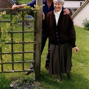 George Baker standing next to a gate with wife louie