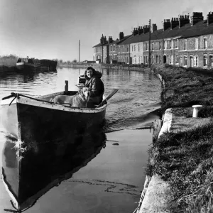 A girl and her dog on a peaceful boat trip on the Leeds and Liverpool canal near Ormskirk