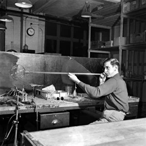 Glass blower Man blowing glass in his workshop. October 1952 C4910-001