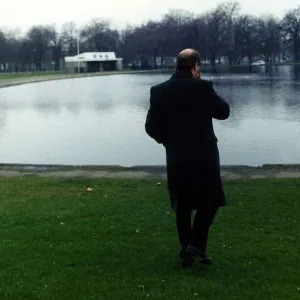 Gorden Kaye actor looking out over a boating lake in winter August 1989