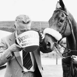 Grand National winner Red Rum with trainer Ginger McCain drinking from bucket 26th