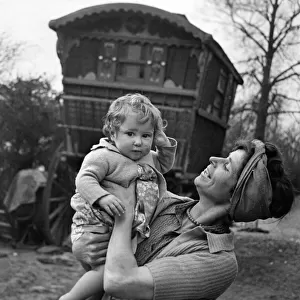 Gypsy woman with child pose outside their caravan. July 1944 P007205
