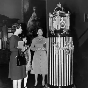 H. M. The Queen H. R. H. Princess Margaret, and Lady Sarah Armstrong Jones looking at a four