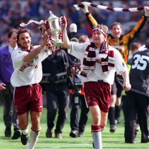 Heart of Midlothian footballer Jim Hamilton carries the Scottish Cup trophy around Celtic