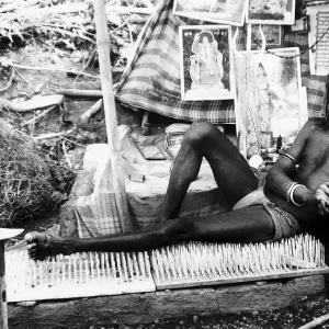 Holy man Kante Wala Baba who has taken a vow of silence on his bed of nails in Rishikesh