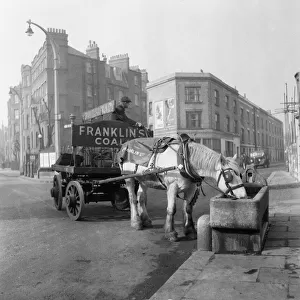 Horse and cart pulling coal through the sreets of London. Franklins Coal June 1955