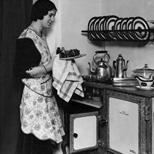 Housewife with her new Flecthers Queensday New World gas regulator oven and hob