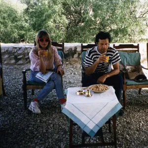 Imran Khan Cricket Sitting in chair outside house drinking with Suzannana Constantine