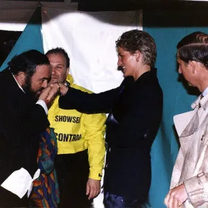 Italian opera singer Luciano Pavarotti kisses the hand of Princess Diana as Prince