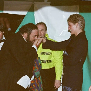 Italian opera singer Luciano Pavarotti kisses the hand of Princess Diana as Prince