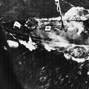 A Japanese cargo ship attacked by a US B-24 Liberator bomber