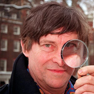 JEREMY BRETT, ACTOR, IN PHOTOCALL FOR SHERLOCK HOLMES, HOLDING MAGNIFYING GLASS