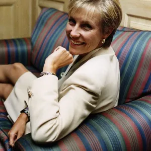 Jill Dando TV Presenter sitting with legs up on sofa