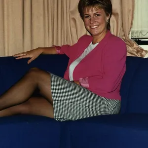 Jill Dando TV Presenter sitting with legs up on sofa on BBC Breakfast time