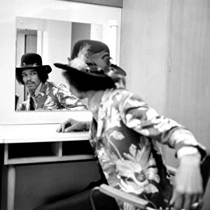 Jimi Hendrix checking his reflection on the date of his new release with Curtis Knight
