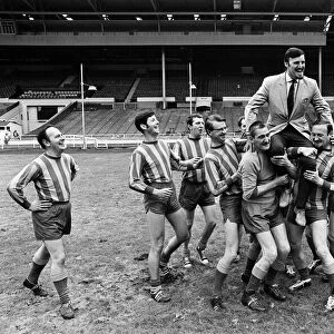 Jimmy Hill pictured being lifted up by a football team. 30th July 1968