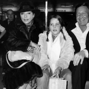 Joan Collins with her husband and her daughter at Heathrow on their way back to San