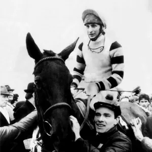 Jockey Phil Tuck on racehorse Burrough Hill Lad, being led into the winners enclosure