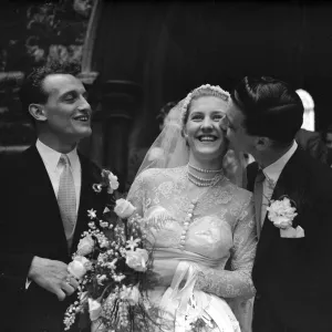 John Haynes, Fulham and England footballer (Right), kisses the bride the fomer Miss