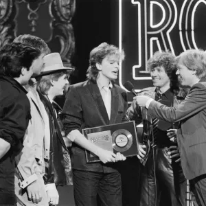 John Taylor, bass player with Duran Duran, receives an award from DJ Kid Jensen