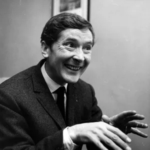 Kenneth Williams comedian hands held out in front in agents office Cork St December